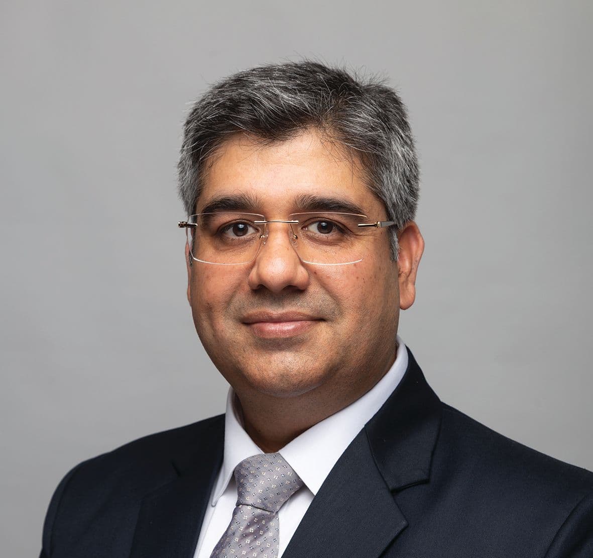 Saurabh Pandhi speaking at a corporate event, portrait with neutral background
